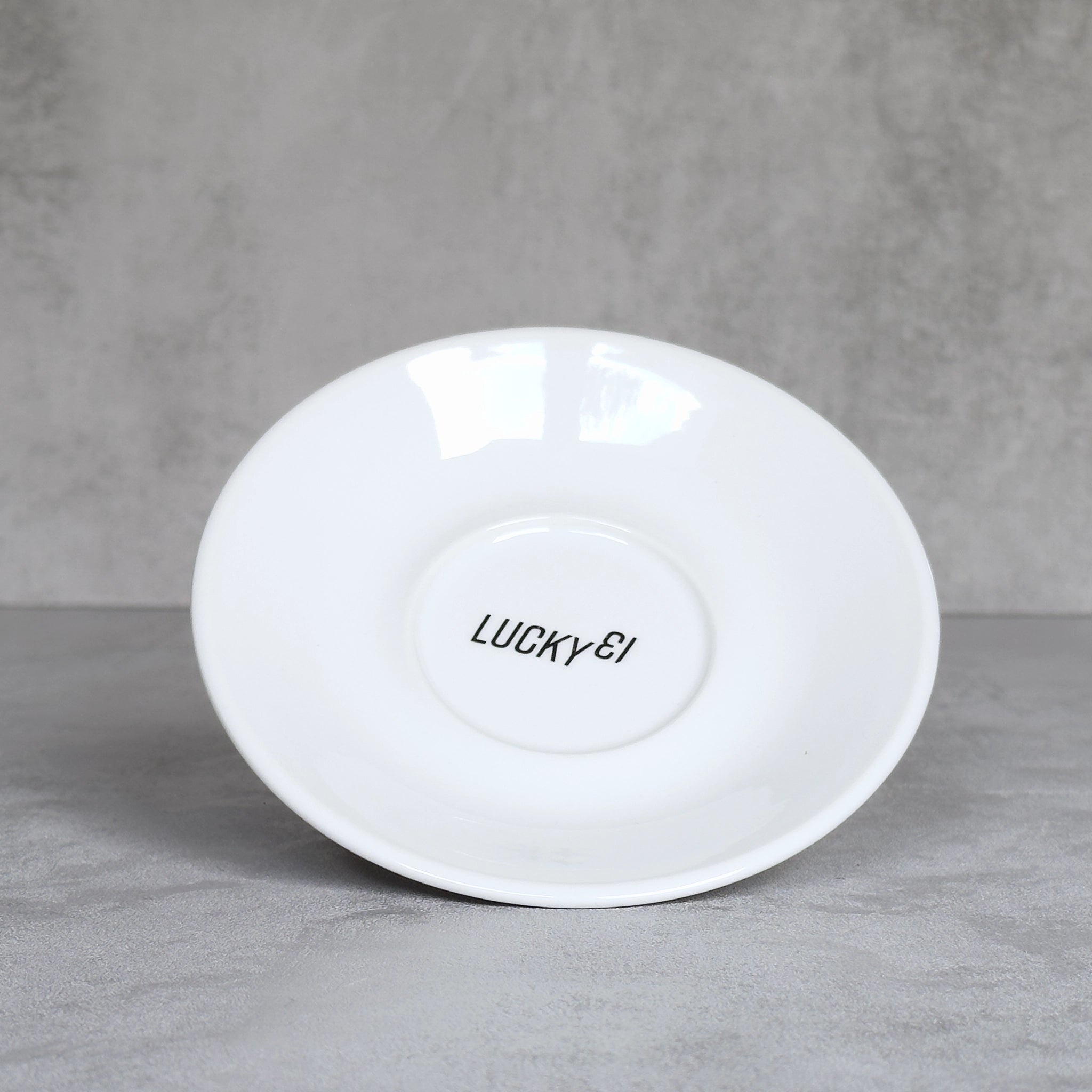 Cappuccino-Untertasse mit Radsport-Slogan Lucky 13